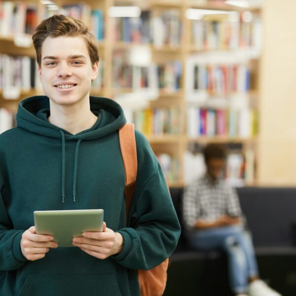 Cheerful high school student with tablet